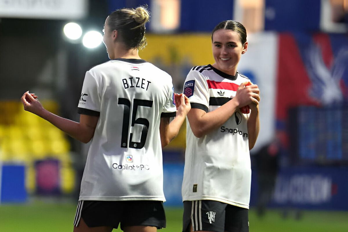 Manchester United's Grace Clinton (right) celebrates with team-mate Celin Bizet Ildhusoy after victory in the Barclays Women's Super League match at the VBS Community Stadium, Sutton.